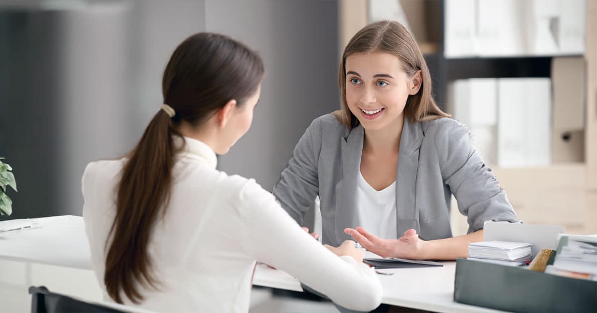 Two young women consulting in office