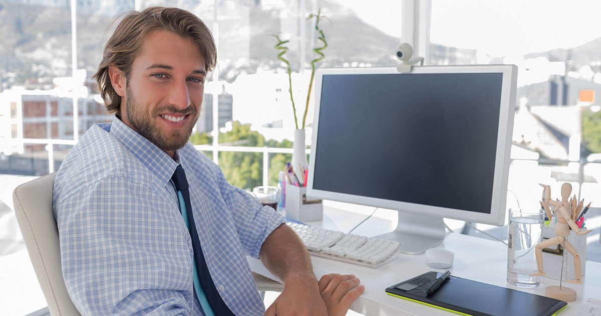 Young professional man at work desk overlooking town