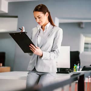 Woman with clipboard in clinical setting