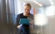 Woman online with computer tablet in foyer