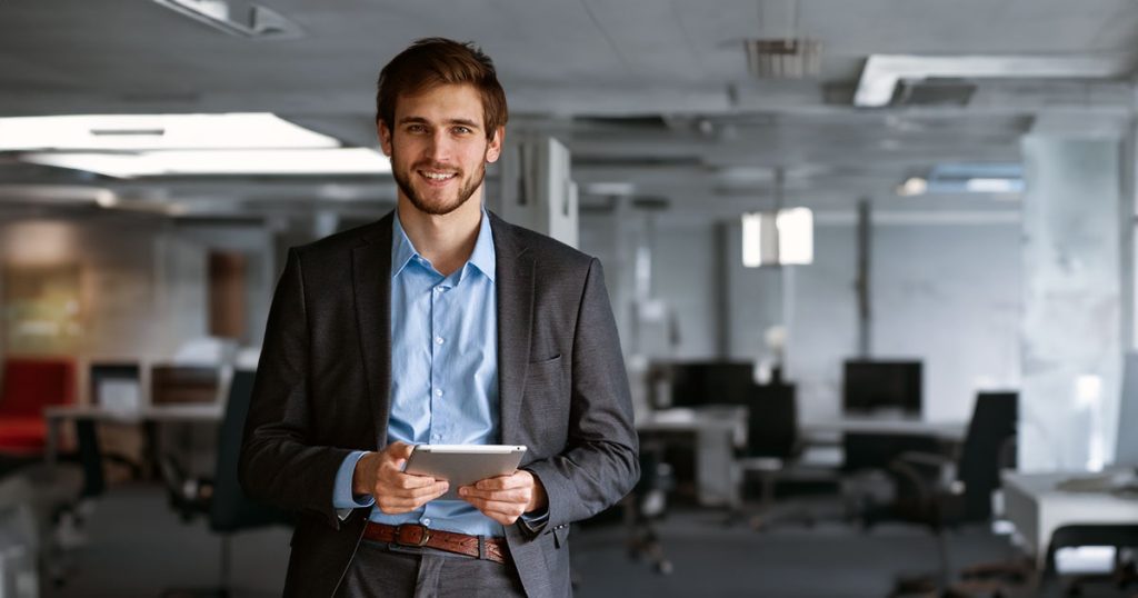 Young businessman in large office space