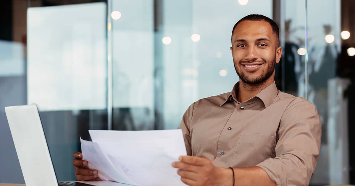 Young male professional reading printouts