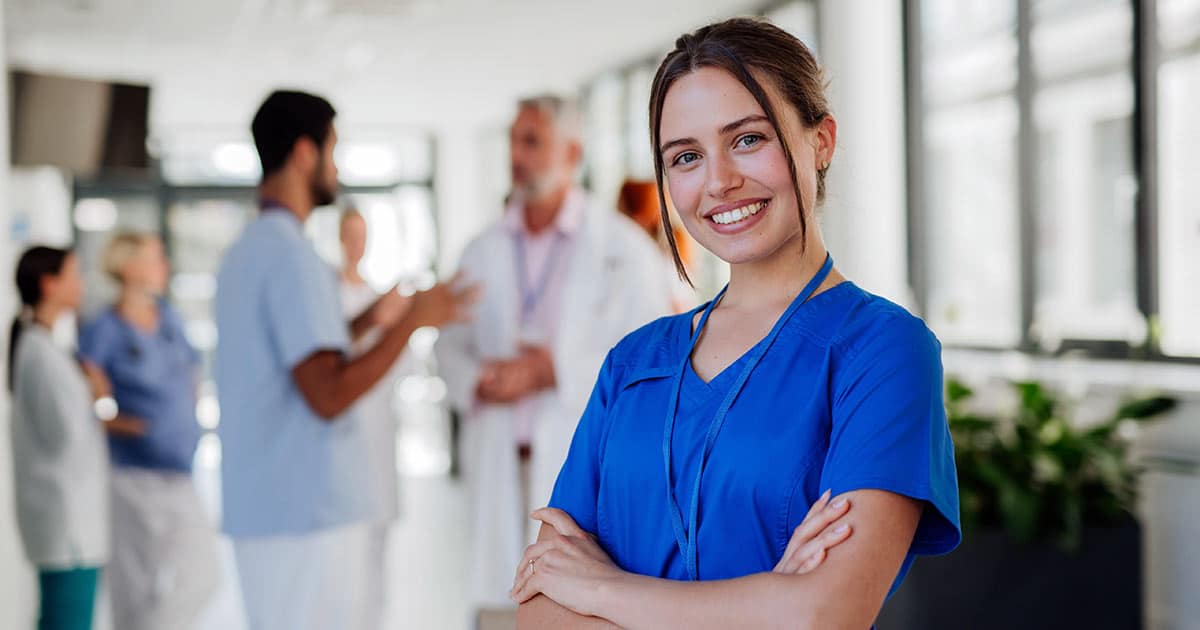 Portrait of young woman nurse at hospital corridor