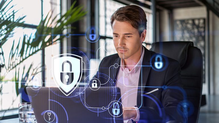 Cybersecurity professional working on a laptop with digital shield, padlock and network security graphics.