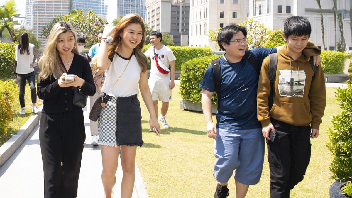 International students from Adelaide University walking and chatting outdoors