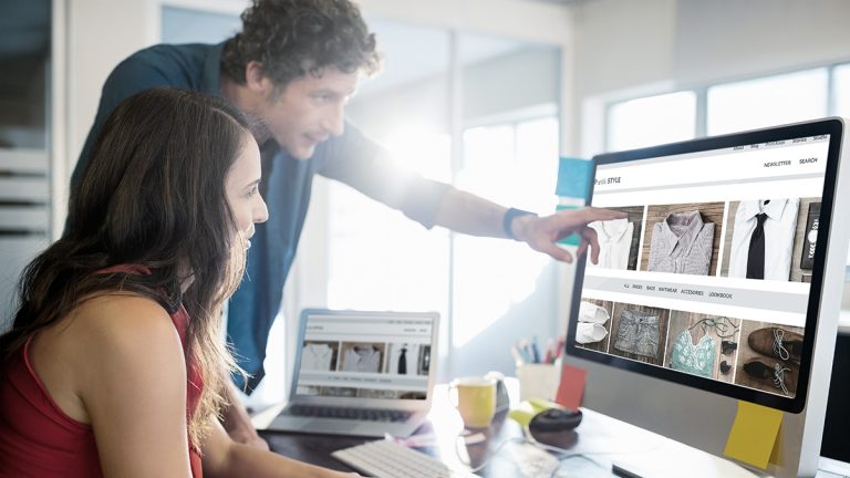 Marketing professionals reviewing an ecommerce website on a desktop computer