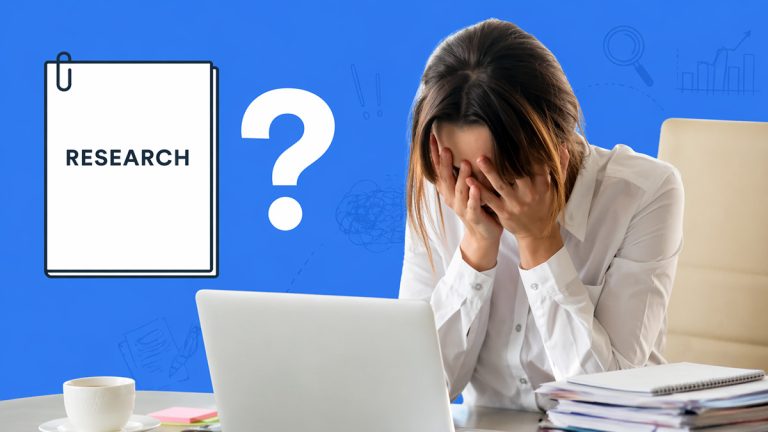 Student covering face at laptop with research paper icon and question mark, showing confusion and stress while writing