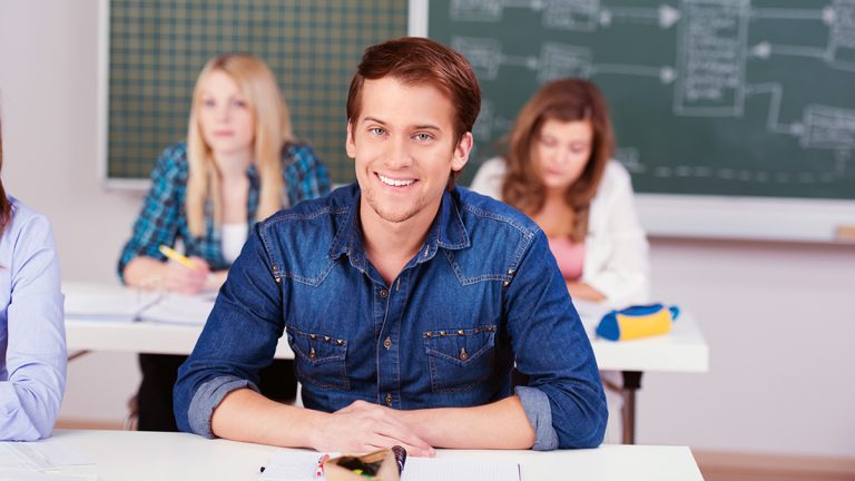 Young adult students seated in a classroom
