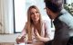 Smiling professional woman in meeting with man