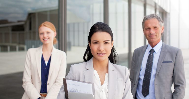 Confident business people outside building