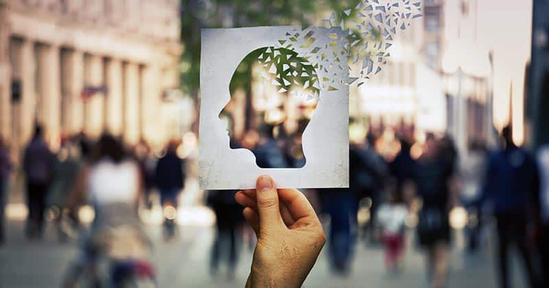 General psychology illustrated by mind symbol held up in front of crowd of people