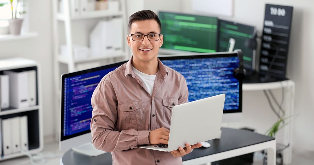 Information technology specialist surrounded by screens