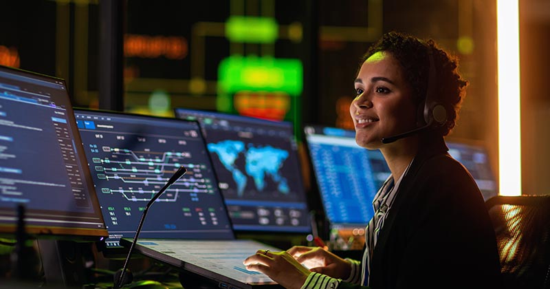 Professional woman in front of high-tech computer screens