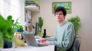 Male college student studying at home