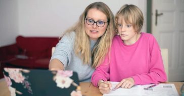 Mother helping daughter with online study