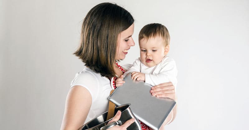 Mother holding baby and laptop