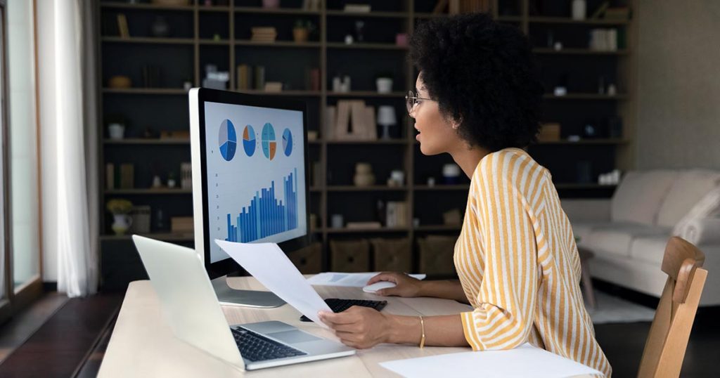 Woman conducting online research viewing a screen showing a chart