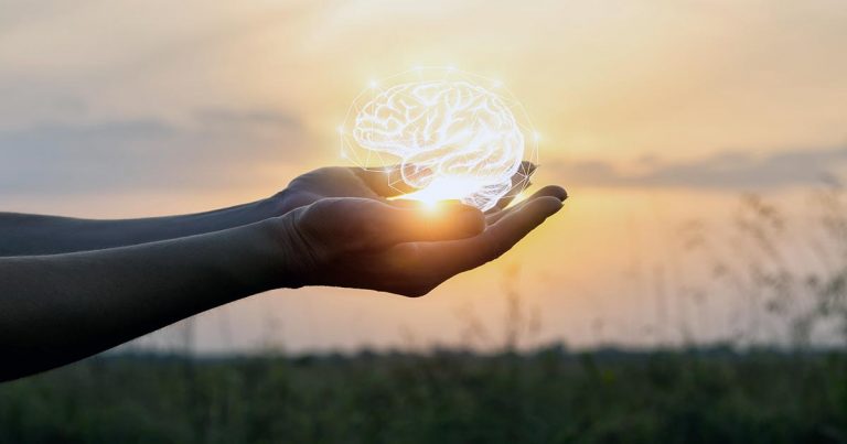 Psychology imagery with brain lit up by setting sun