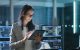 Woman standing using tablet inside computer lab