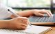 Young woman writing and taking notes